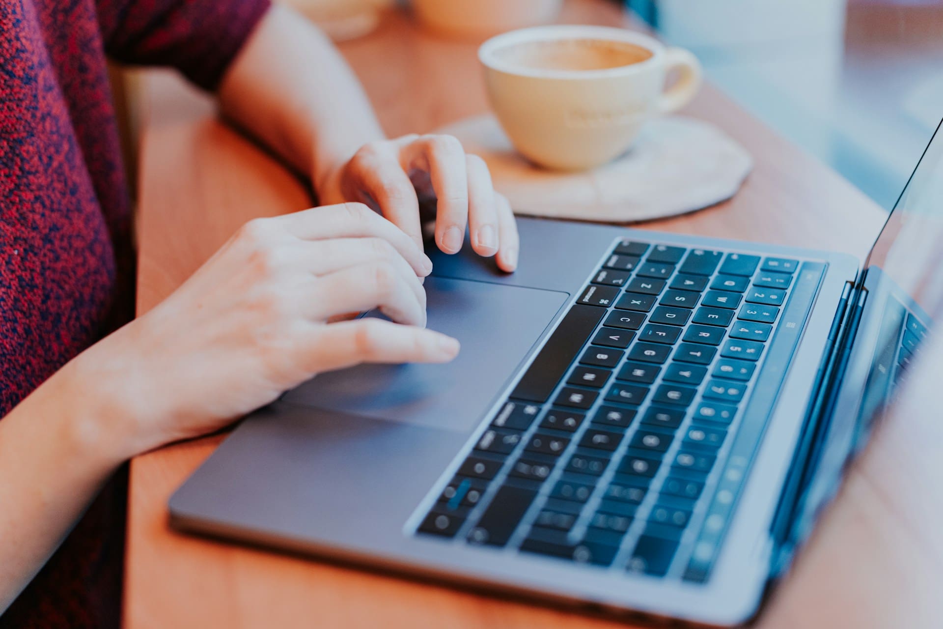 Human hands hovering over a keyboard