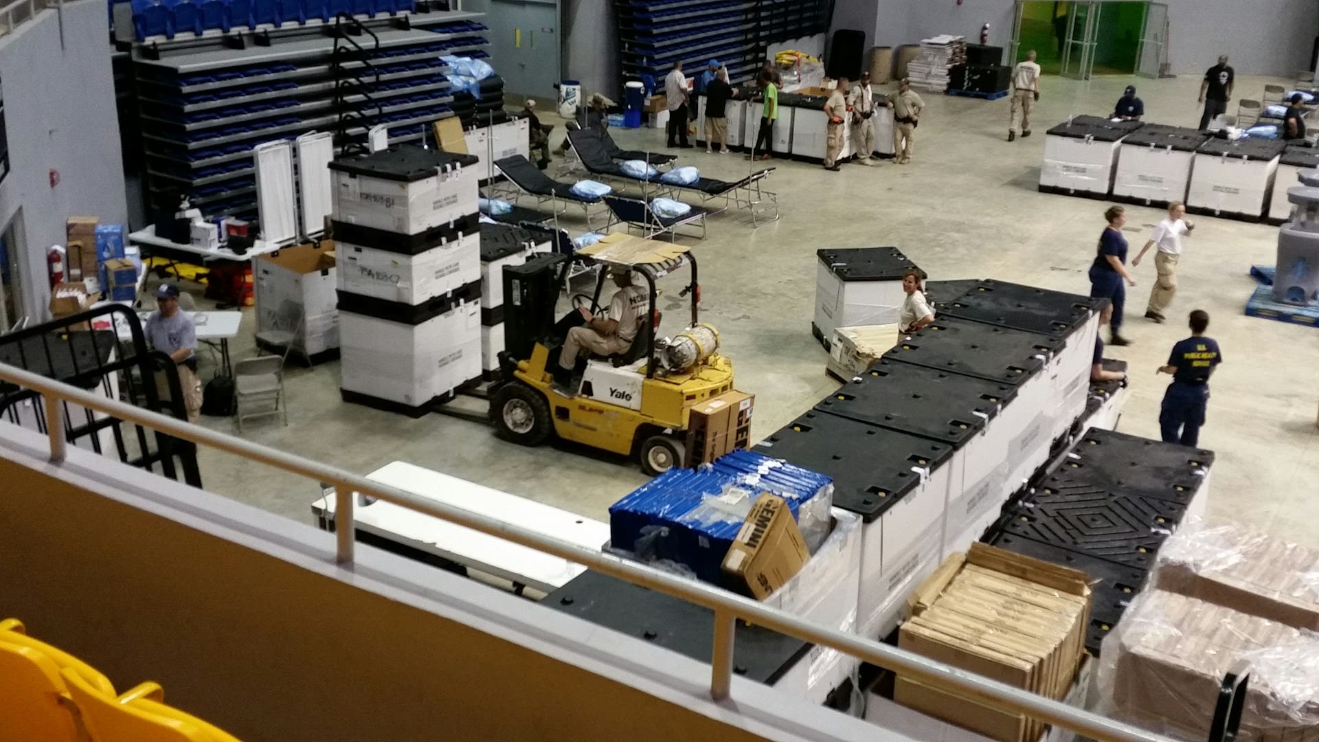 A busy warehouse with plenty of movement, people, and vehicles